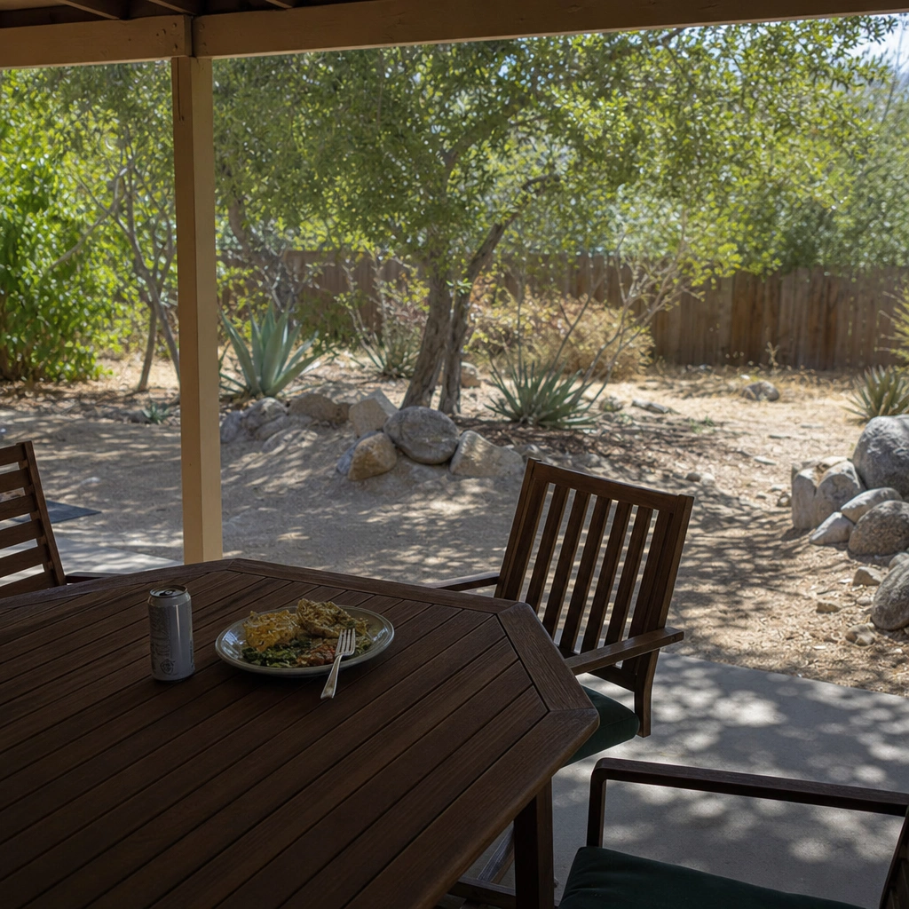 A backyard patio table with food and drink left out, the late-summer setting where wasp control in Kennewick matters most